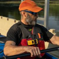 man in a single kayak using an accessible launch to get onto the water